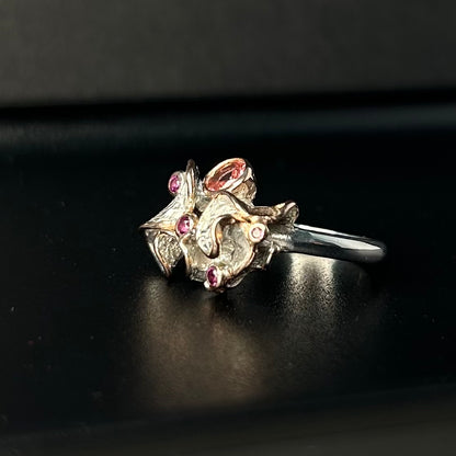 Silver ring with gemstones on a black background
