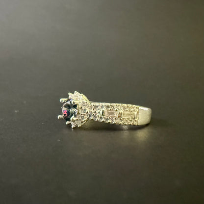 Silver ring with a colorful mystic quartz on a light purple background