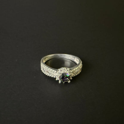 Silver ring with a colorful mystic quartz on a light purple background
